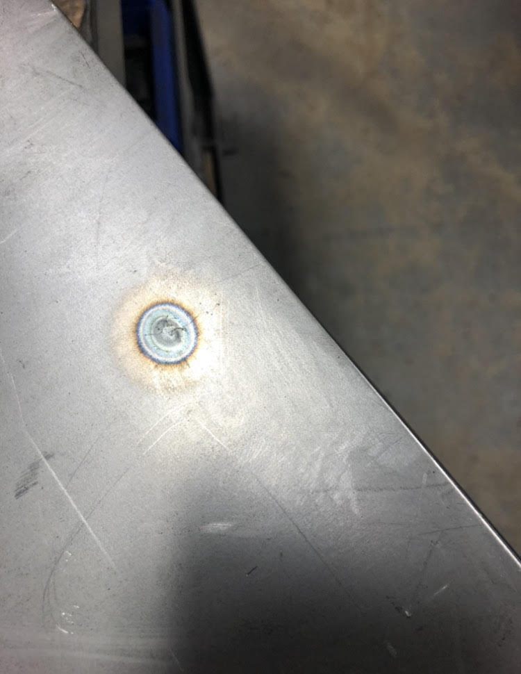 Melt-through from a tack weld on thin gauge material. 